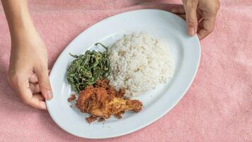 Ayam goreng Kalasan and Gulai daun ubi, Indonesian traditional cuisine made from fried chicken photo