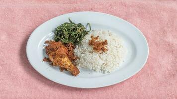 Ayam goreng Kalasan and Gulai daun ubi, Indonesian traditional cuisine made from fried chicken photo