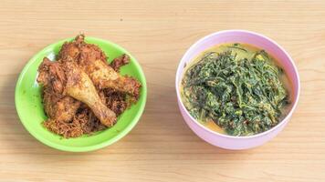 Ayam goreng Kalasan and Gulai daun ubi, Indonesian traditional cuisine made from fried chicken photo