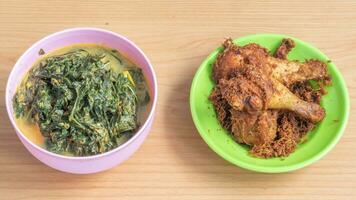 Ayam goreng Kalasan and Gulai daun ubi, Indonesian traditional cuisine made from fried chicken photo