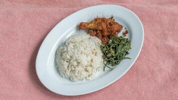 Ayam goreng Kalasan and Gulai daun ubi, Indonesian traditional cuisine made from fried chicken photo