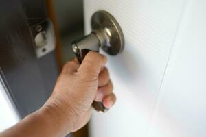 Human hands open and close a room door photo