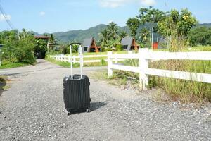 Black suitcase of a tourist arriving at his accommodation photo