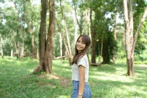 world saving concept Happy female tourist amidst forest photo