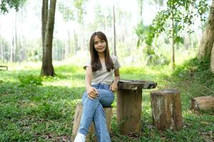 world saving concept Happy female tourist amidst forest photo