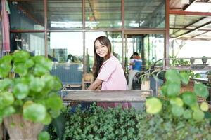 Happy Asian woman in coffee shop photo