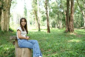 world saving concept Happy female tourist amidst forest photo