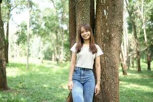 world saving concept Happy female tourist amidst forest photo