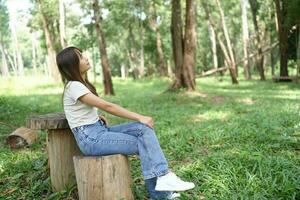 world saving concept Happy female tourist amidst forest photo