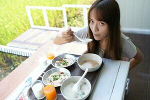 Asian female tourists eating breakfast photo