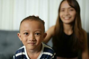 Mother and son smiling happily inside the house photo