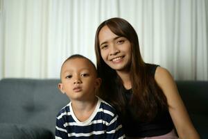 Mother and son smiling happily inside the house photo