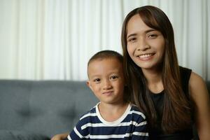 Mother and son smiling happily inside the house photo