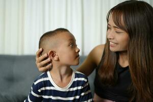 Mother and son smiling happily inside the house photo