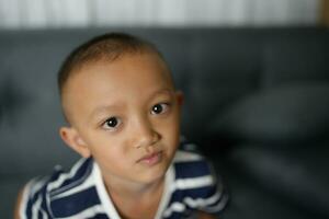 An Asian boy gave him a look that begged for pity. photo