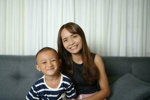 Mother and son smiling happily inside the house photo