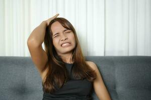 Asian woman has headache from work stress photo