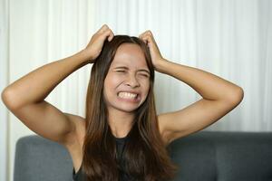 Asian woman has itchy scalp photo