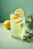 Glass of tasty lemonade with rosemary and lime on color background, AI Generative photo