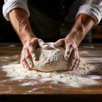 Flour-covered hands forming dough into perfect round shapes photo