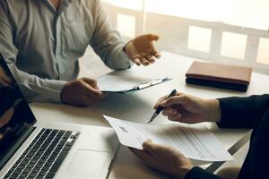 Smart businessman professional man in suit executive gesturing and talking in meeting with interview employee about work in modern office. photo