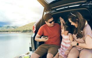 Summer vacations.Happy family enjoying trip with their favorite car. Holiday and travel family concept. photo