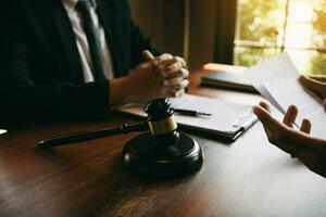 Client is explaining the offense to the lawyer and working together to solve the problem of the offense. photo
