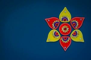 Diwali festival decorative object that can put with diwa lamp for decoration on blue background. photo