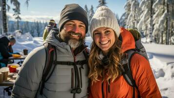 Couples snowshoeing in winter gear pausing for hot drinks and toasted sandwiches photo