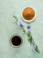 Chicory coffee, flowers, powder and ready-made coffee in a cup. photo