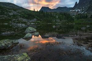 Stunning sunrise on the lake. Lake Radughnoe in Ergaki on an sum photo