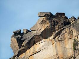 Crumbling rock. Abstract crumbling cliff rock formation. Eroding rock cliffs. photo