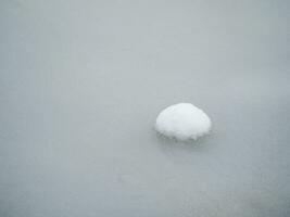 Selective focus. Spring ice, small snowy round island on melting ice. Abstract natural background. photo