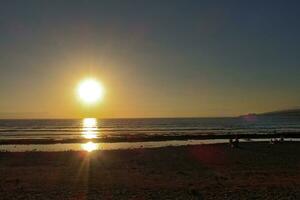 picturesque ocean landscape with the setting sun in a tropical country during summer holidays photo