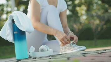 young woman runner tying shoelaces video