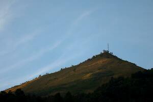 view of the peaks of several mountains at sunrise in the morning photo