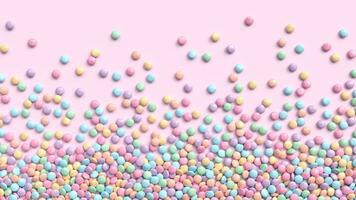 Colorful coated chocolate candies in pastel tones scattered on pink background photo