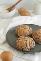 Cookies with cream and eggs on a plate, selective focus. photo