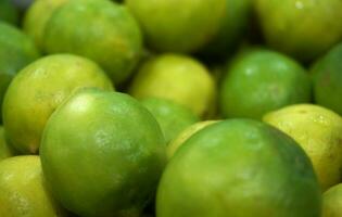 Limes in the market, close-up, selective focus. photo