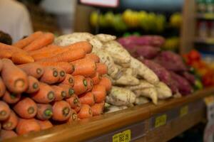 Fresh carrots on the counter of a grocery store. Selective focus. photo