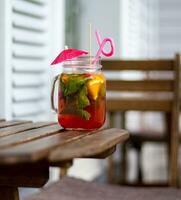 Refreshing summer drink with lemon and mint in a glass jar photo