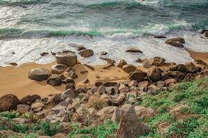Tropical beach with rocks and sea waves. Beautiful nature background photo