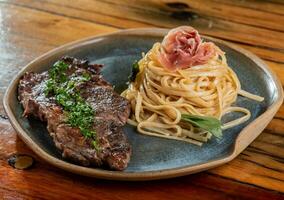 Spaghetti with beef and parmesan on a wooden table. photo