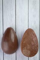 Chocolate Easter eggs on wooden background. Top view with copy space photo