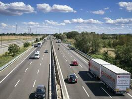 cars trucks person and stocks on motorway photo