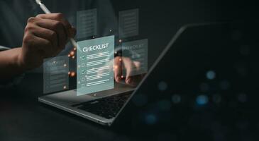 business management with document check list at work place. Man holding pen mark on checklist report virtual screen. photo