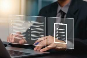 Concept of compliance rules and law Standard Quality Control Certification Assurance Warranty checkbox icon through laptops. photo
