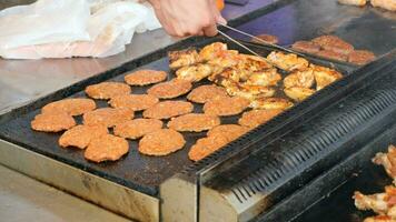 Beef and chicken steaks on the grill with flames. video