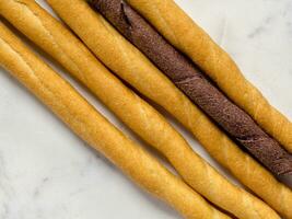 Grissini italian crunchy bread sticks lay flat isolated on studio. photo