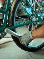 at the bike shop store and repair , mechanic expert repairs restore and wreck bycicle photo